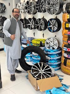 City Wheels owner on the shop floor with new tyres and alloy rims