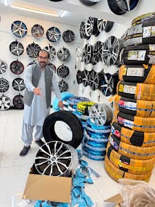 City Wheels owner in the showroom beside the rim wall