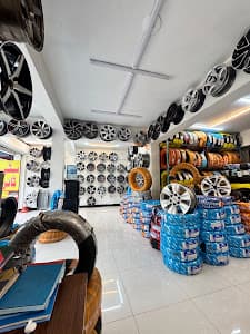 Inside the City Wheels showroom: alloy rims on the walls and tyres stacked in racks